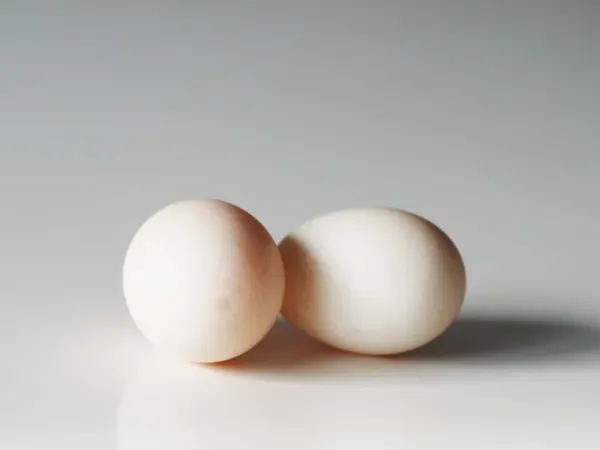 two duck eggs on a table before being prepared for babies starting solid food