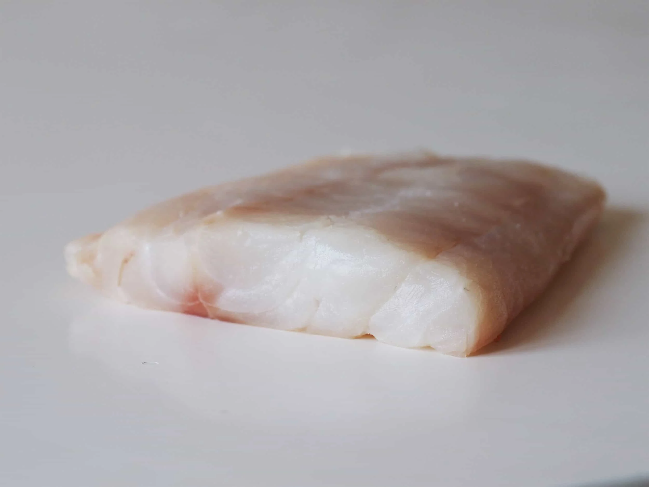 a piece of fresh cod to be prepared for a baby starting solids with baby-led weaning