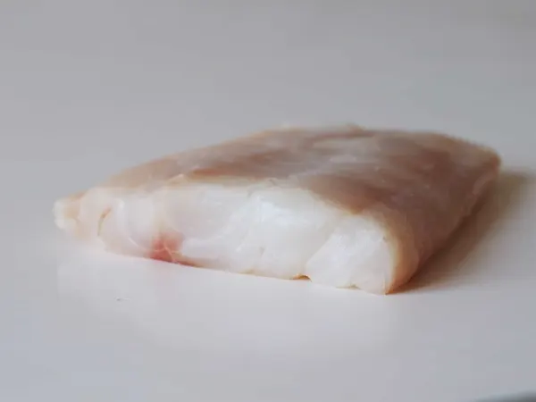 a piece of fresh cod to be prepared for a baby starting solids with baby-led weaning