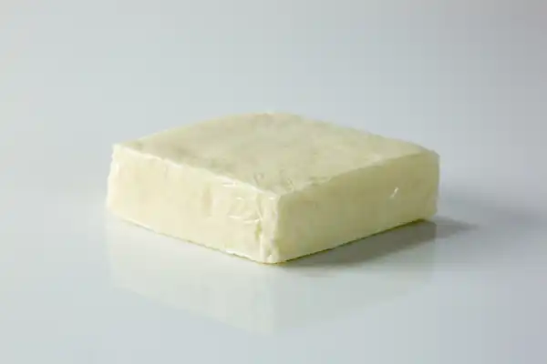 a block of paneer on a white background ready to be prepared for babies starting solids