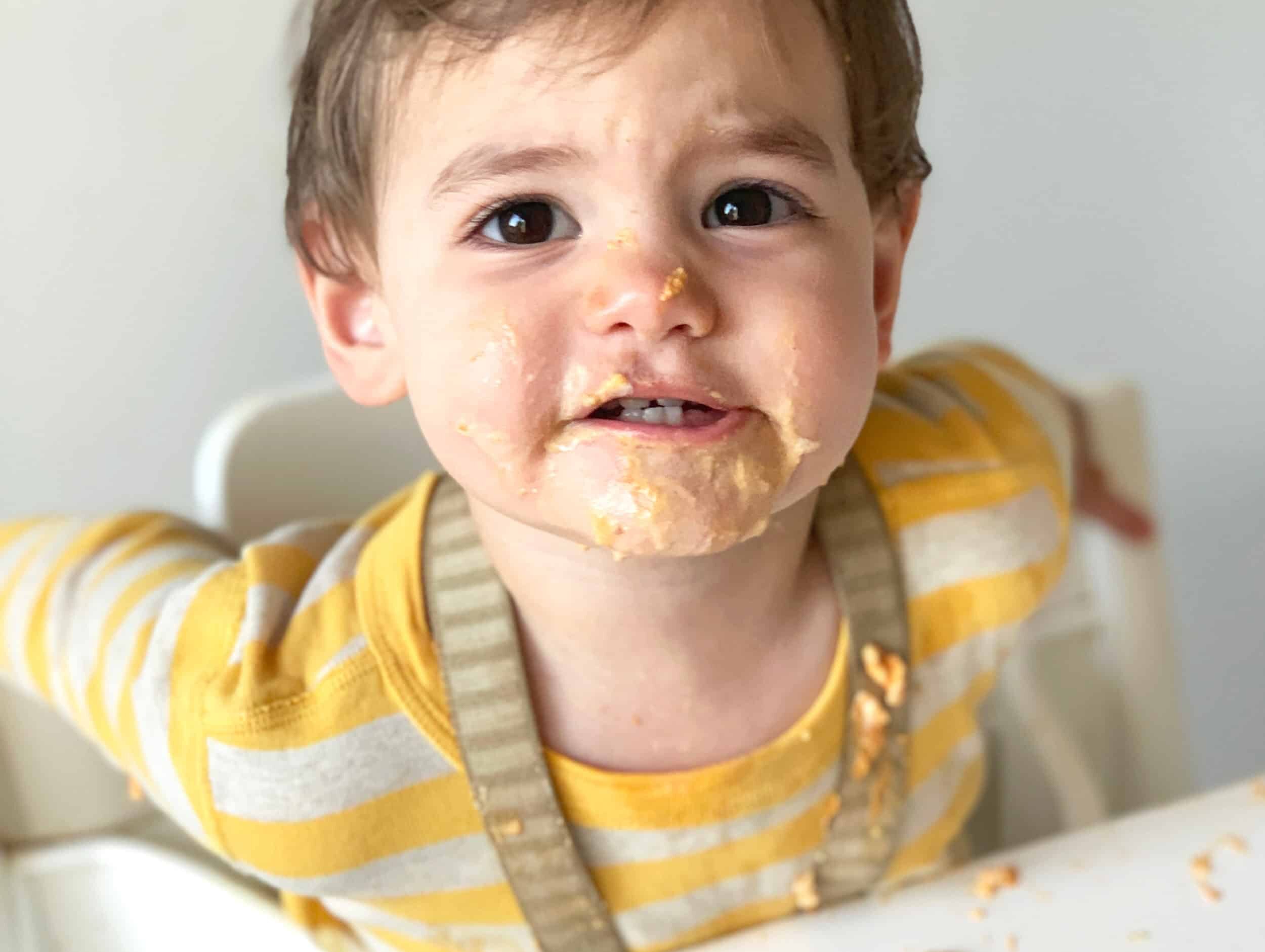 baby covered in food with the title Minimizing the Mess