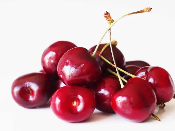 A pile of cherries before they have been prepared for a baby starting solid foods