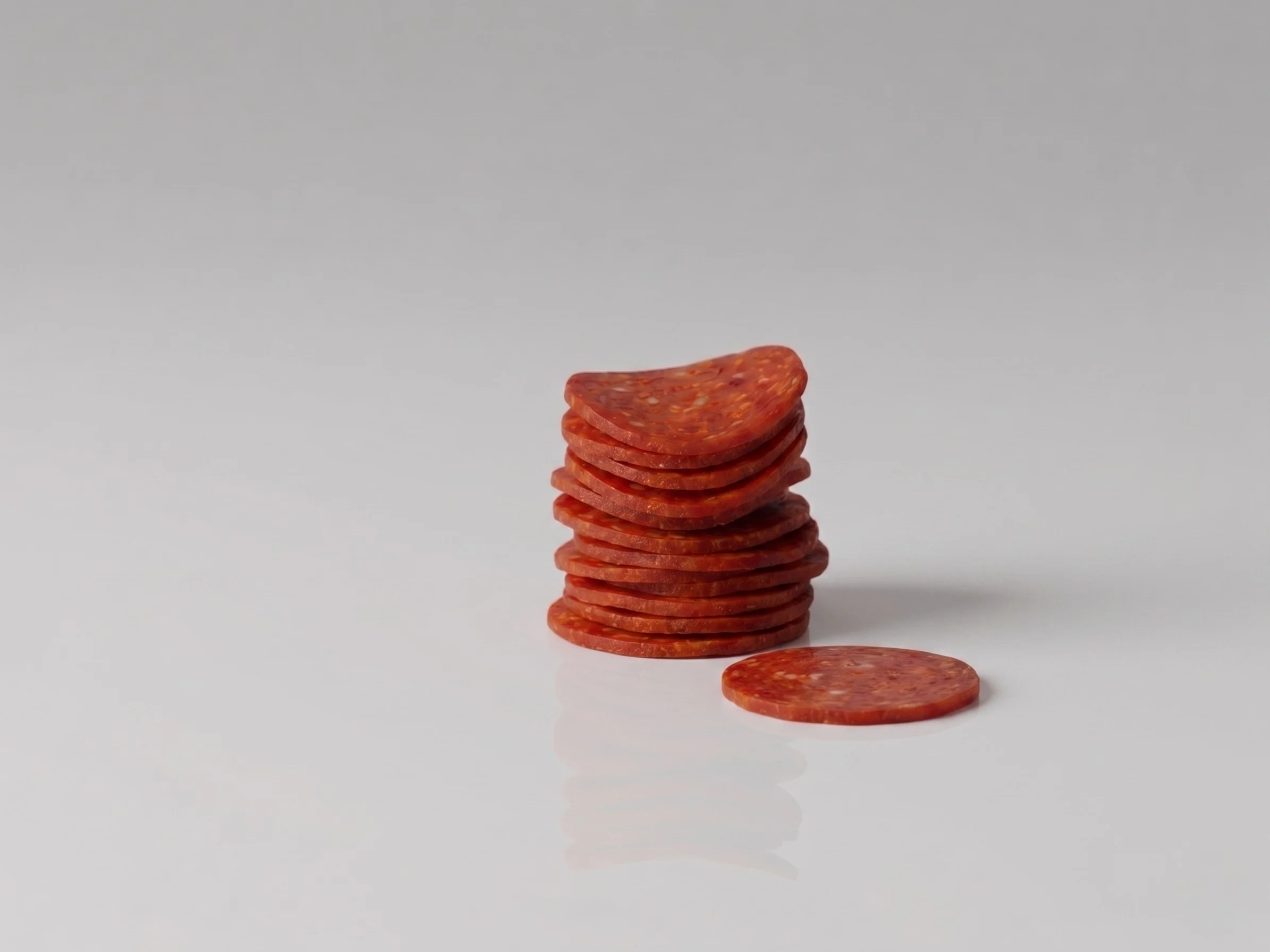 a photograph of a small pile of thin slices of pepperoni