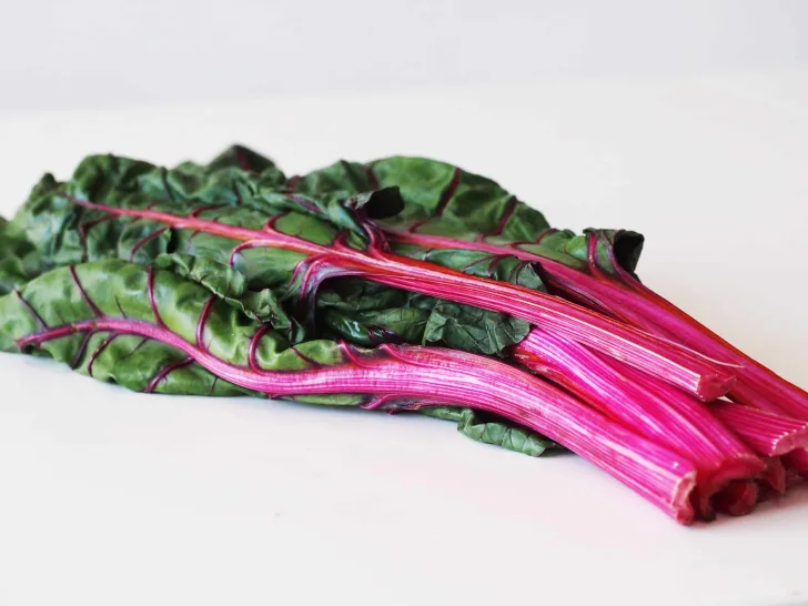 a bundle of swiss chard with pink stems before being prepared for babies starting solids