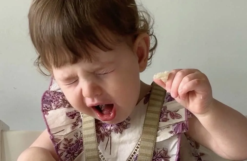 a baby gags on a food when starting solids