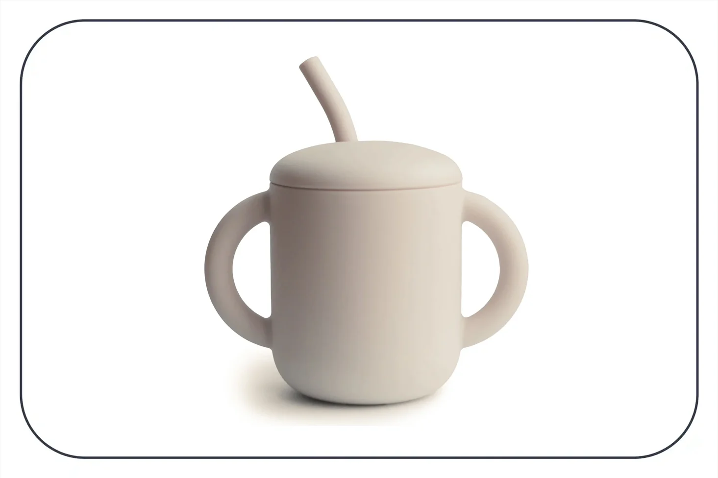 a photograph of a beige Mushie straw cup with handles