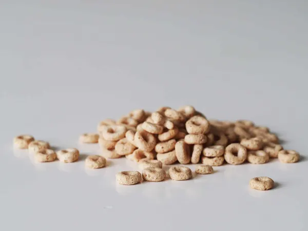 a pile of Cheerios on a grey background ready for babies 9 months+