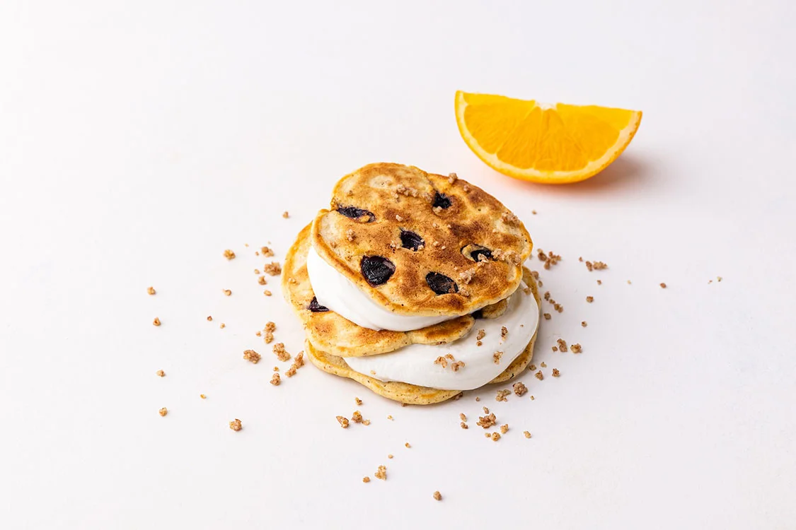 two pancakes with berries and mint on top