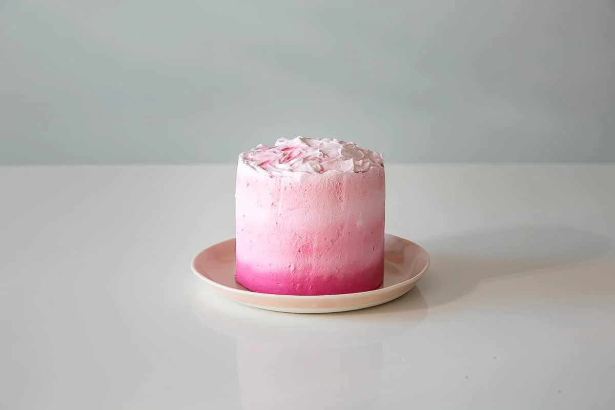a pink birthday cake before baby's first birthday