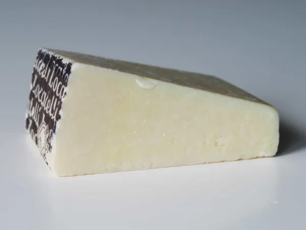 A wedge of pecorino cheese before it has been prepared for a baby starting solid foods