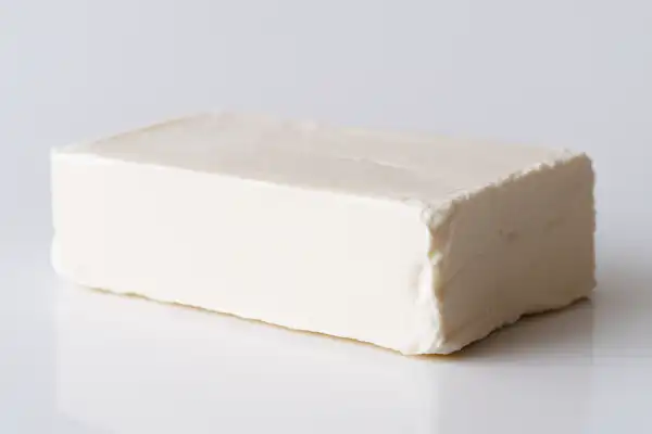a whole block of American style neufchatel on a white background