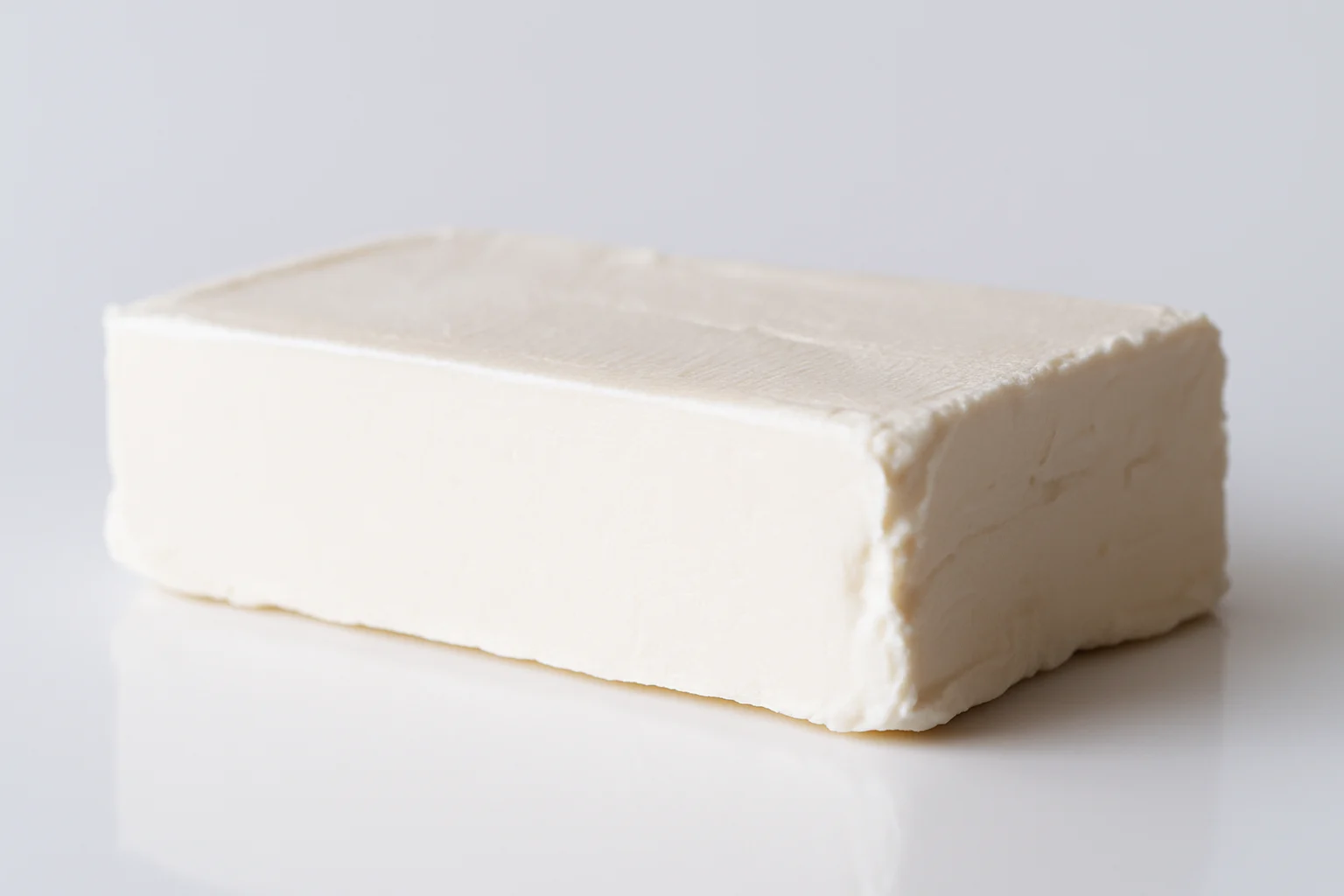 a whole block of American style neufchatel on a white background