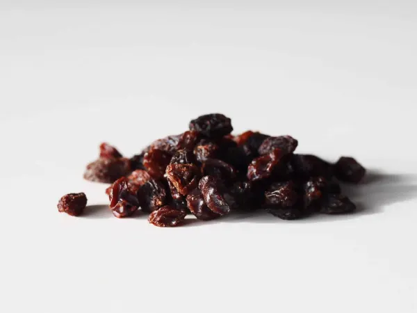 a pile of purple raisins on a table before being prepared for babies starting solid food