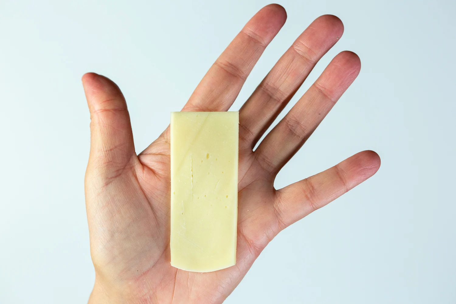Provolone long flat slice hand pic