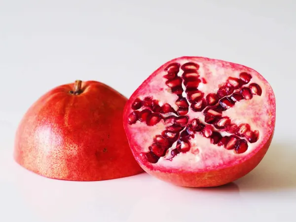 a pomegranate cut open before being prepared for babies starting solids