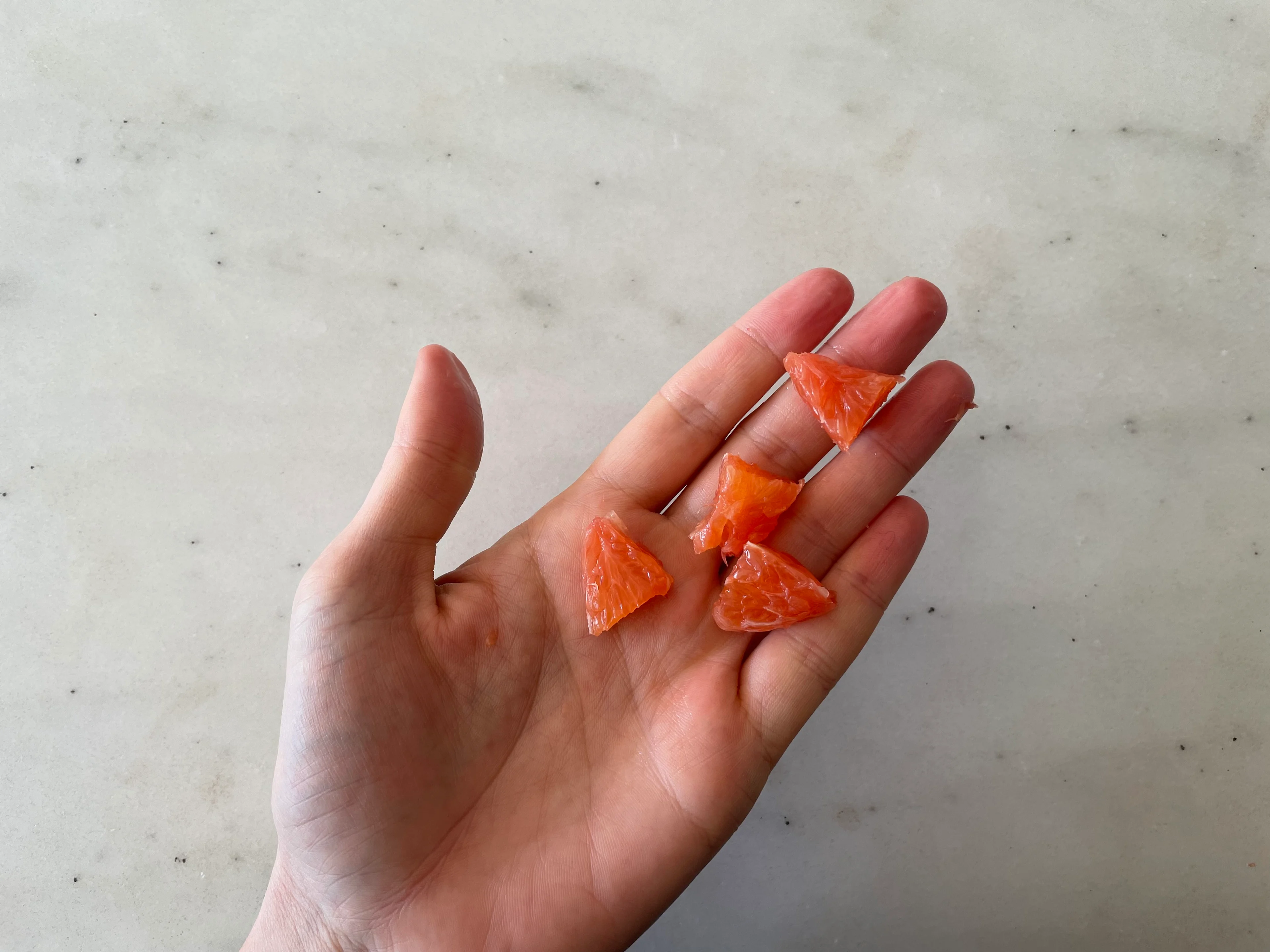 Orange bite-sized pieces hand pic