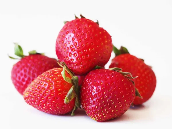 A pile of pA pile of strawberries before they have been prepared for a baby starting solid foods