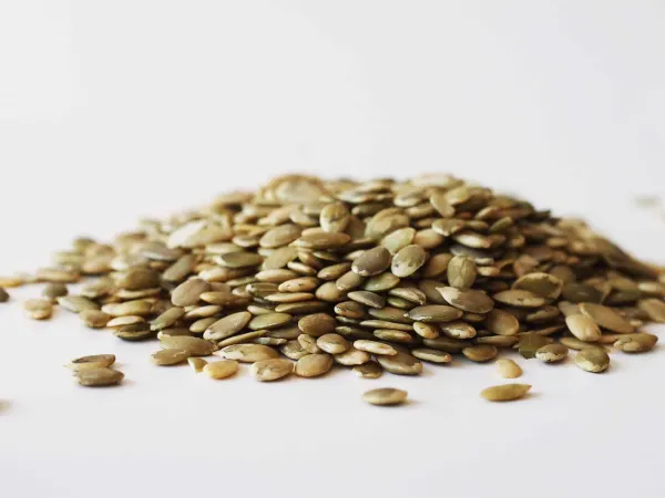 A pile of pumpkin seeds before they have been prepared for a baby starting solid foods