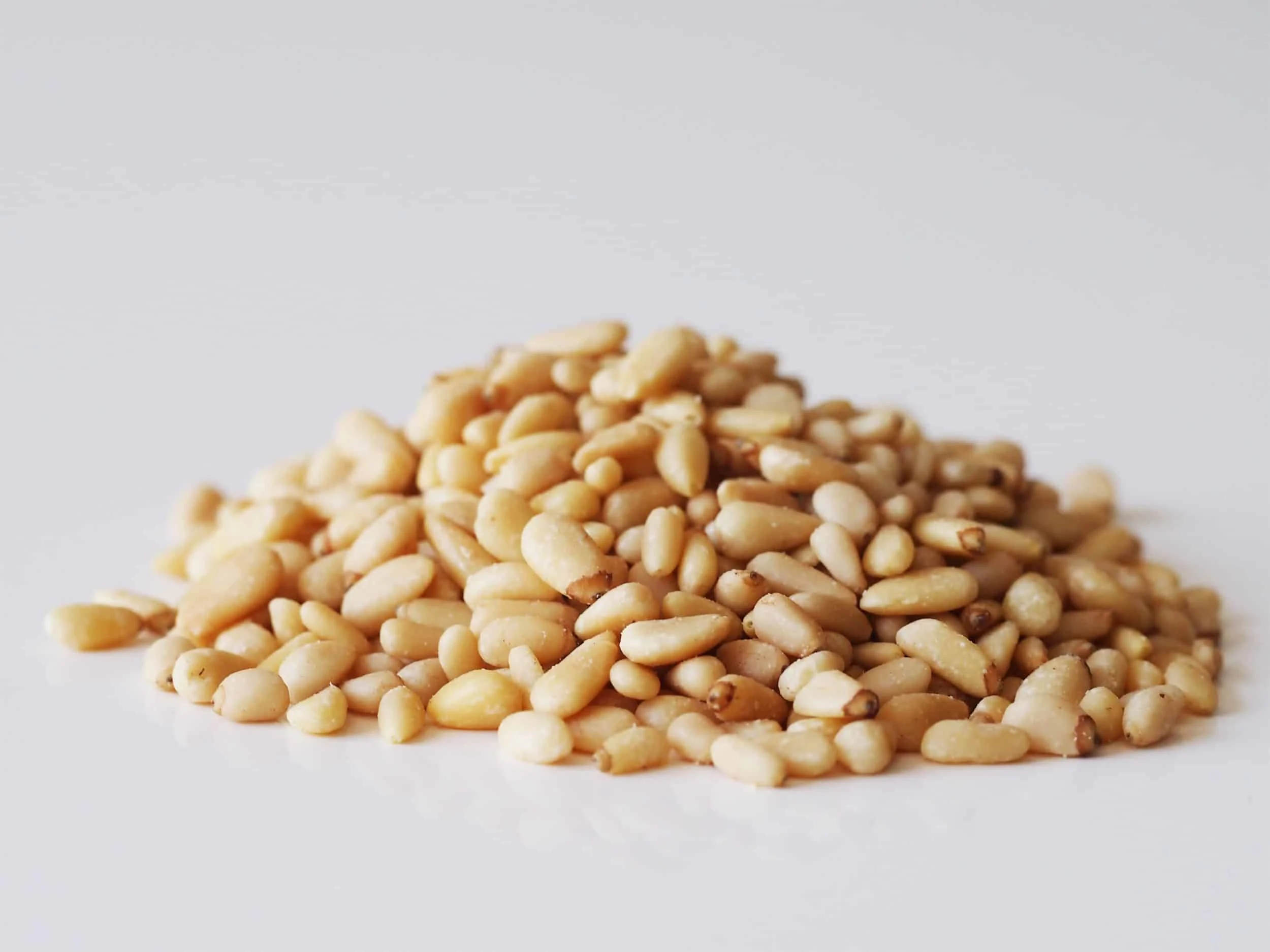A pile of pine nuts before being prepared for babies starting solid food