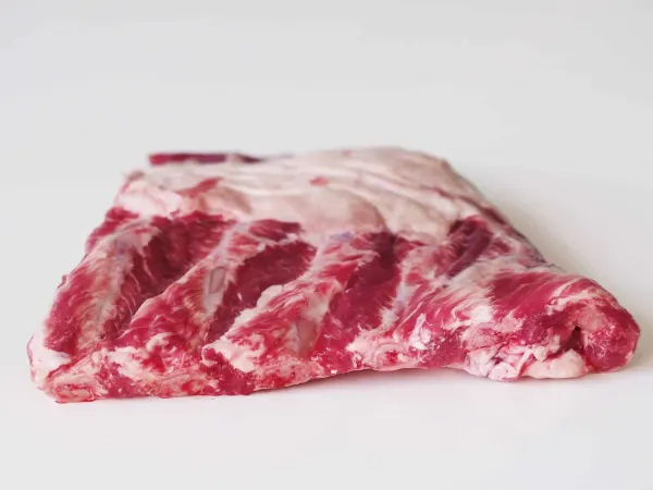 a rack of raw spare ribs before being prepared for a baby starting solids