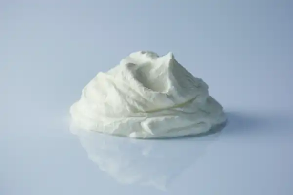 a photograph of a pile of skyr on a white reflective surface
