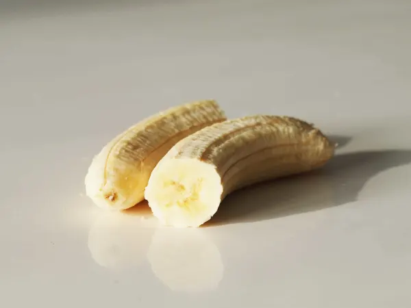 a banana split in half prepared for a baby starting solids