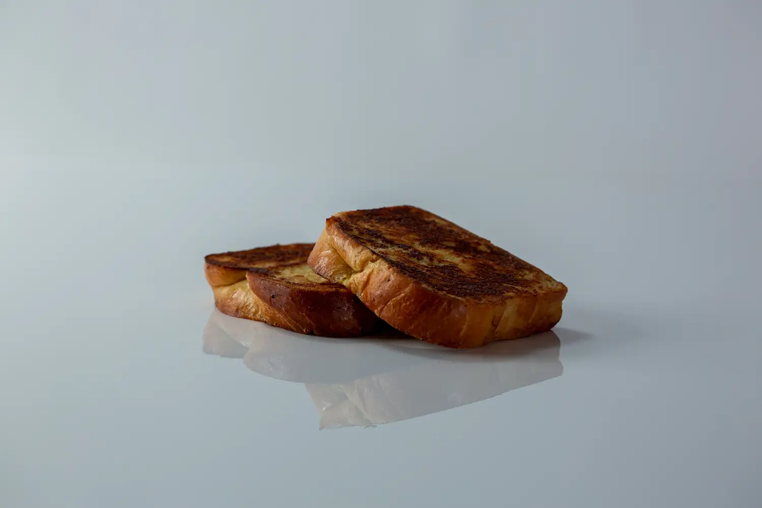 two slices of french toast on a white background