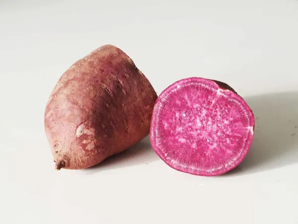 a purple potato, cut in half before being prepared for a baby starting solids