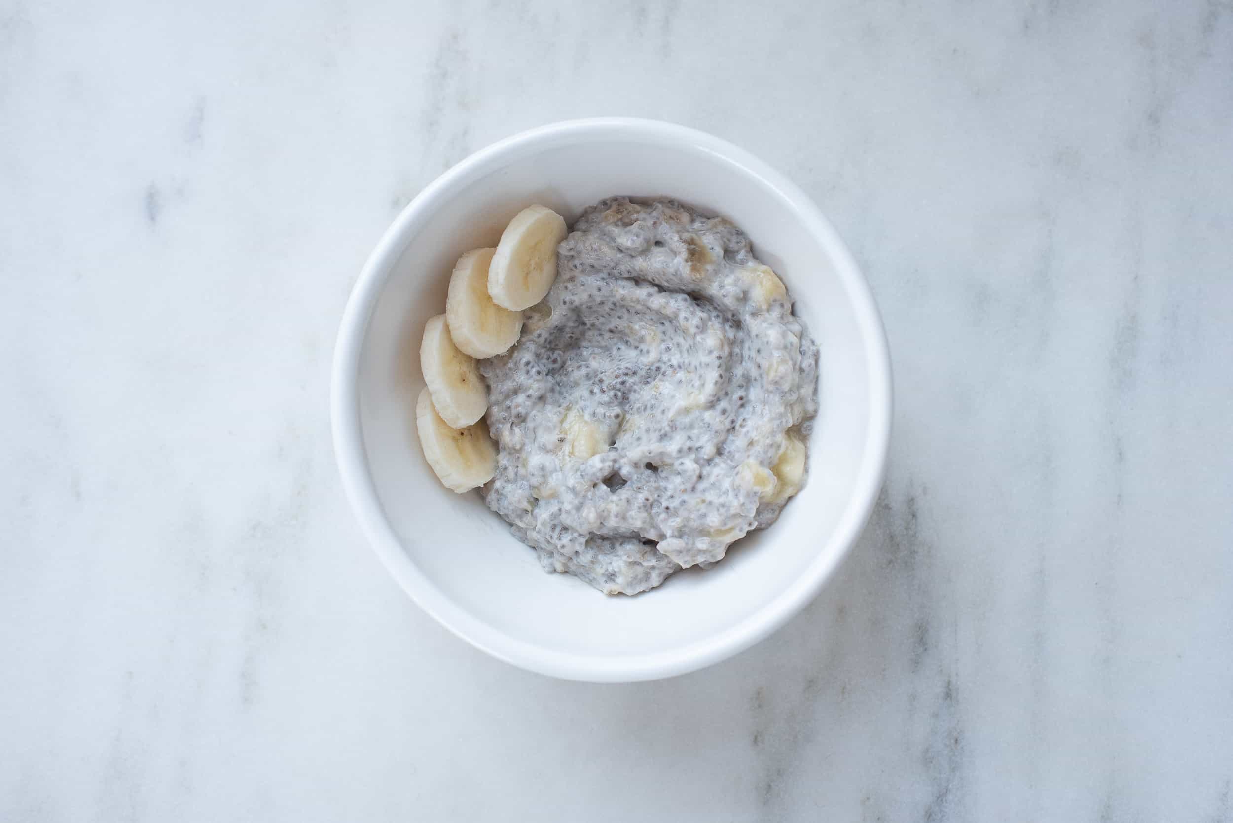 bowl of chia pudding topped with sliced bananas
