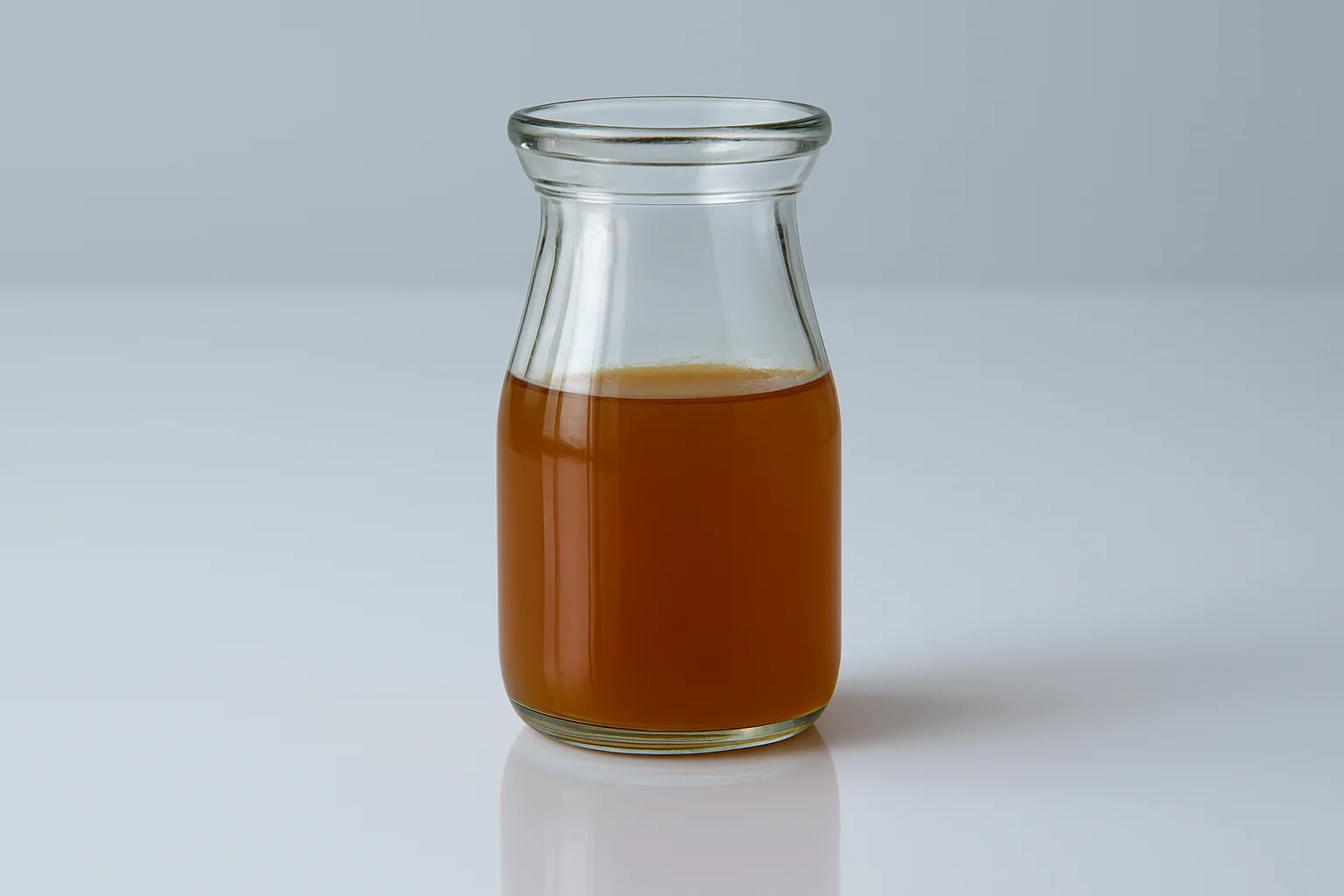 a photograph of a glass container of vegetable stock