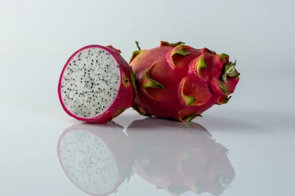 a photograph of a dragonfruit cut in half to show the inside