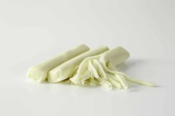 three sticks of string cheese on a white background, one of them partially pulled apart into strands
