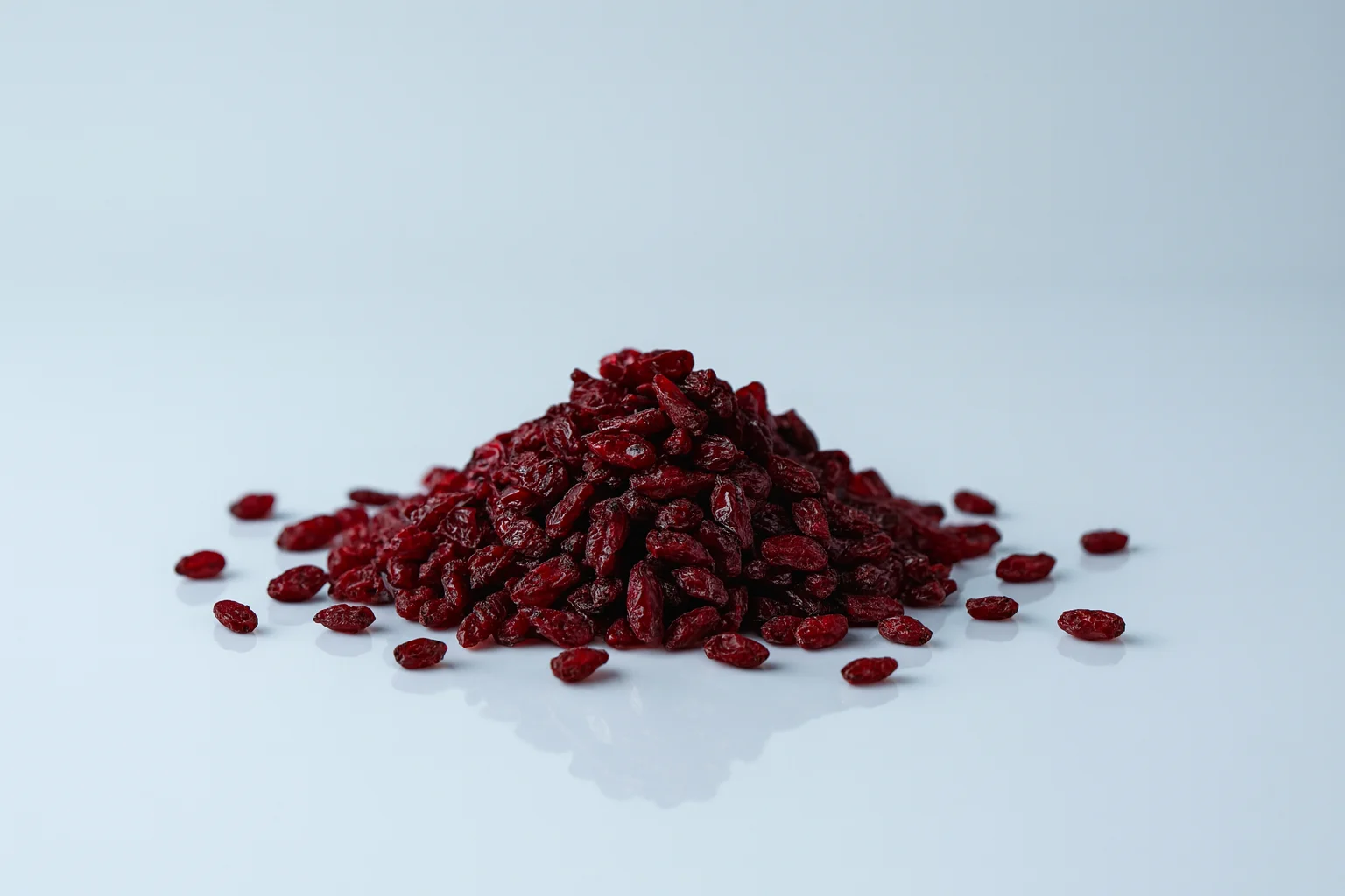 a pile of dried barberries on a white background