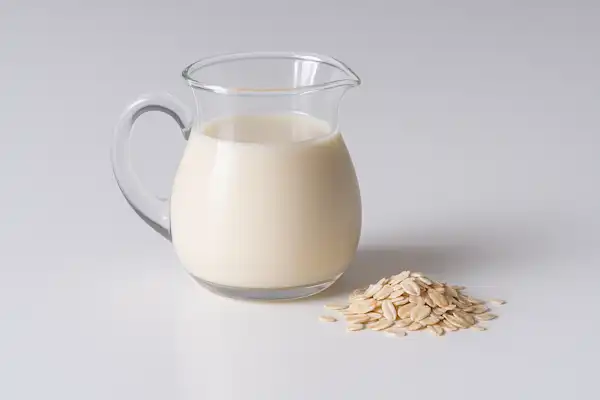 a photograph of oat milk and oats