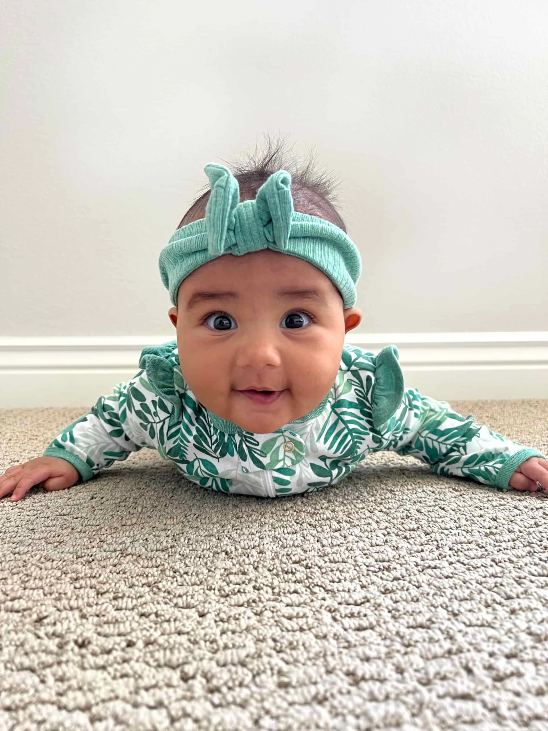 Maya, 5 months, does tummy time in preparation for starting solids