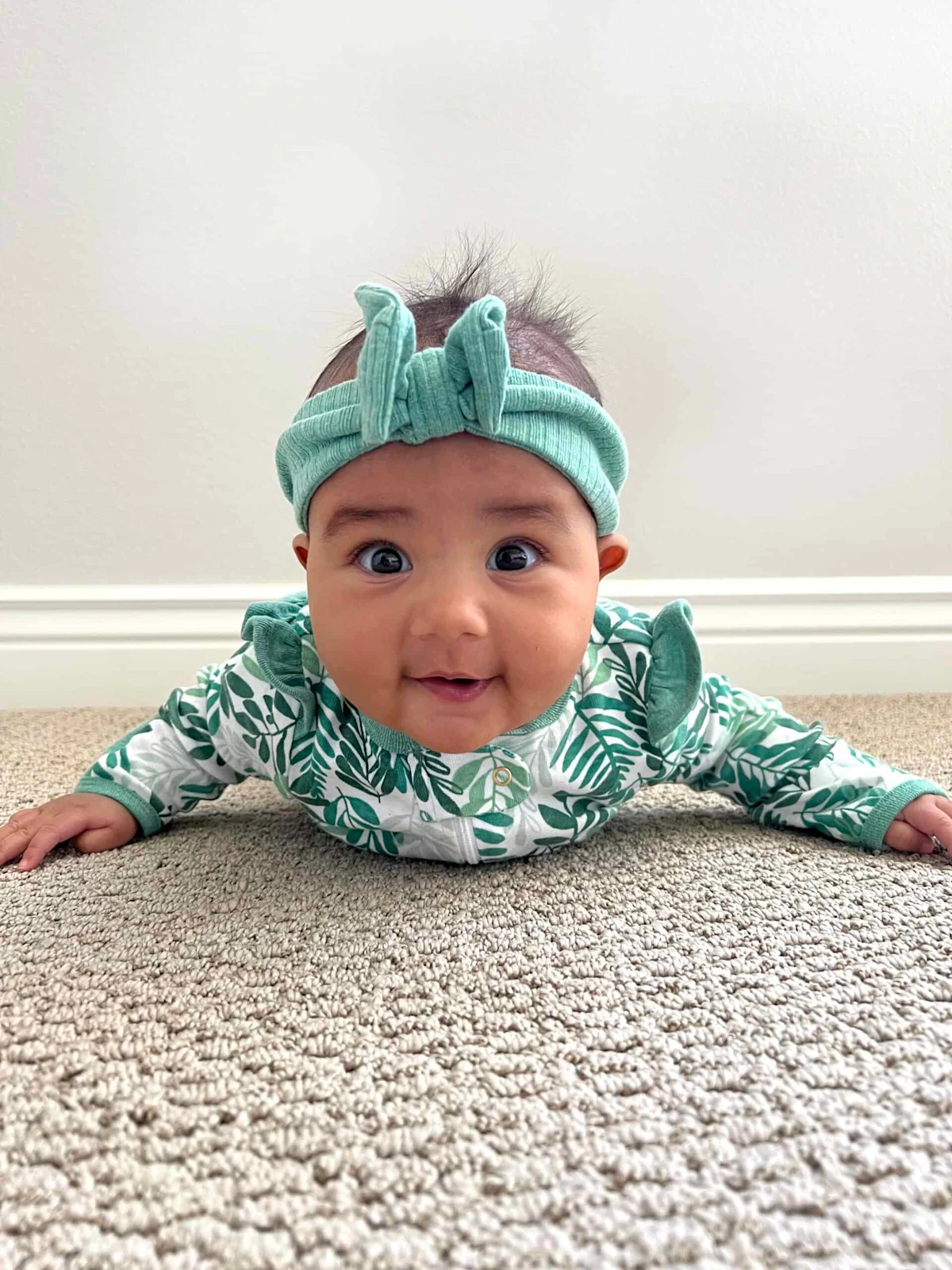 Maya, 5 months, does tummy time in preparation for starting solids