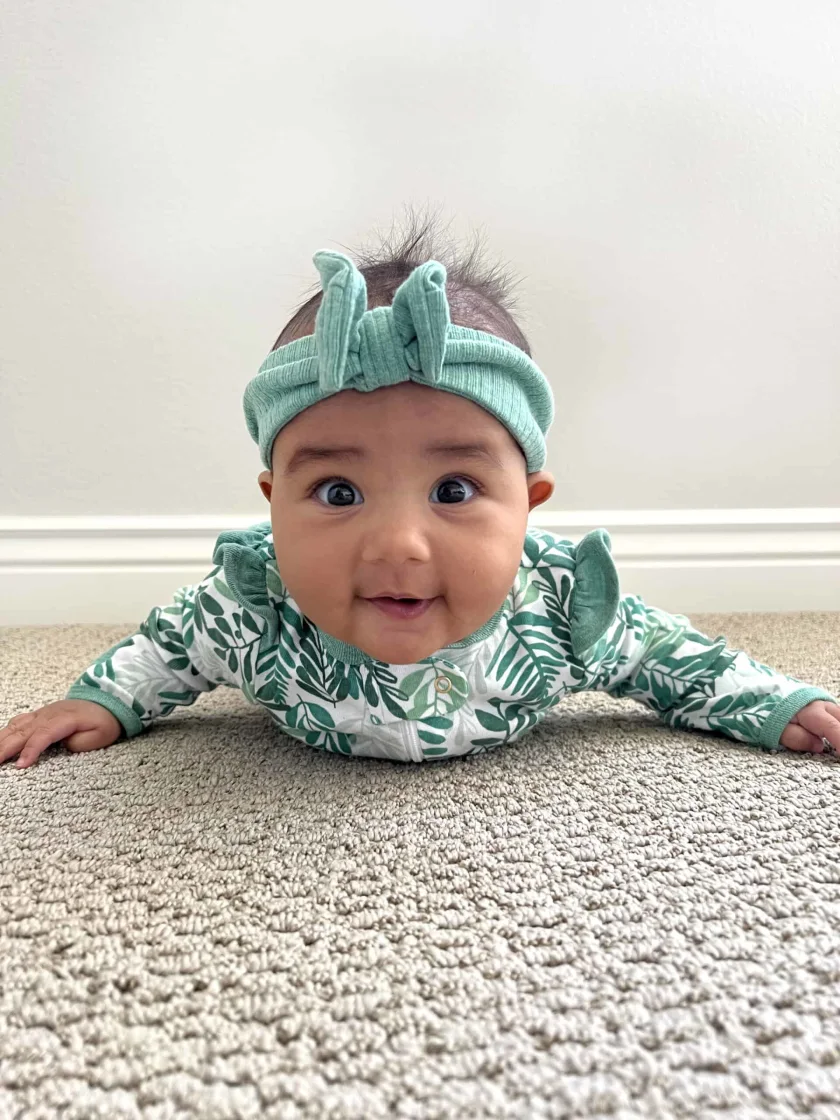 Maya, 5 months, does tummy time in preparation for starting solids
