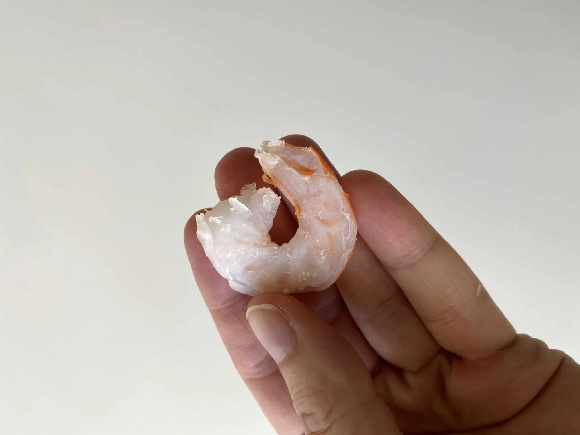 a whole shrimp cut in half lengthwise