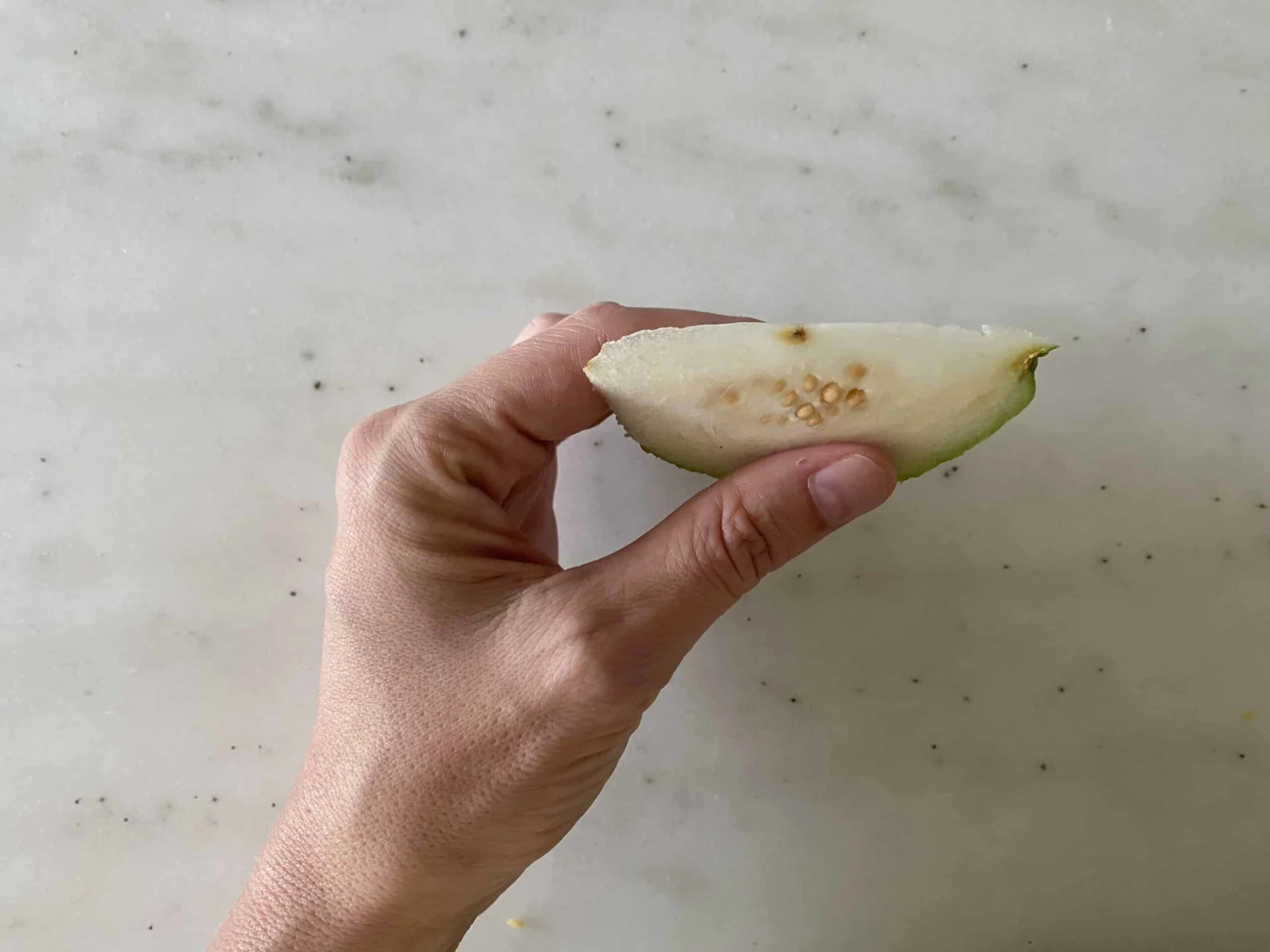 A thin slice of guava (firm variety) before being prepared for babies starting solids