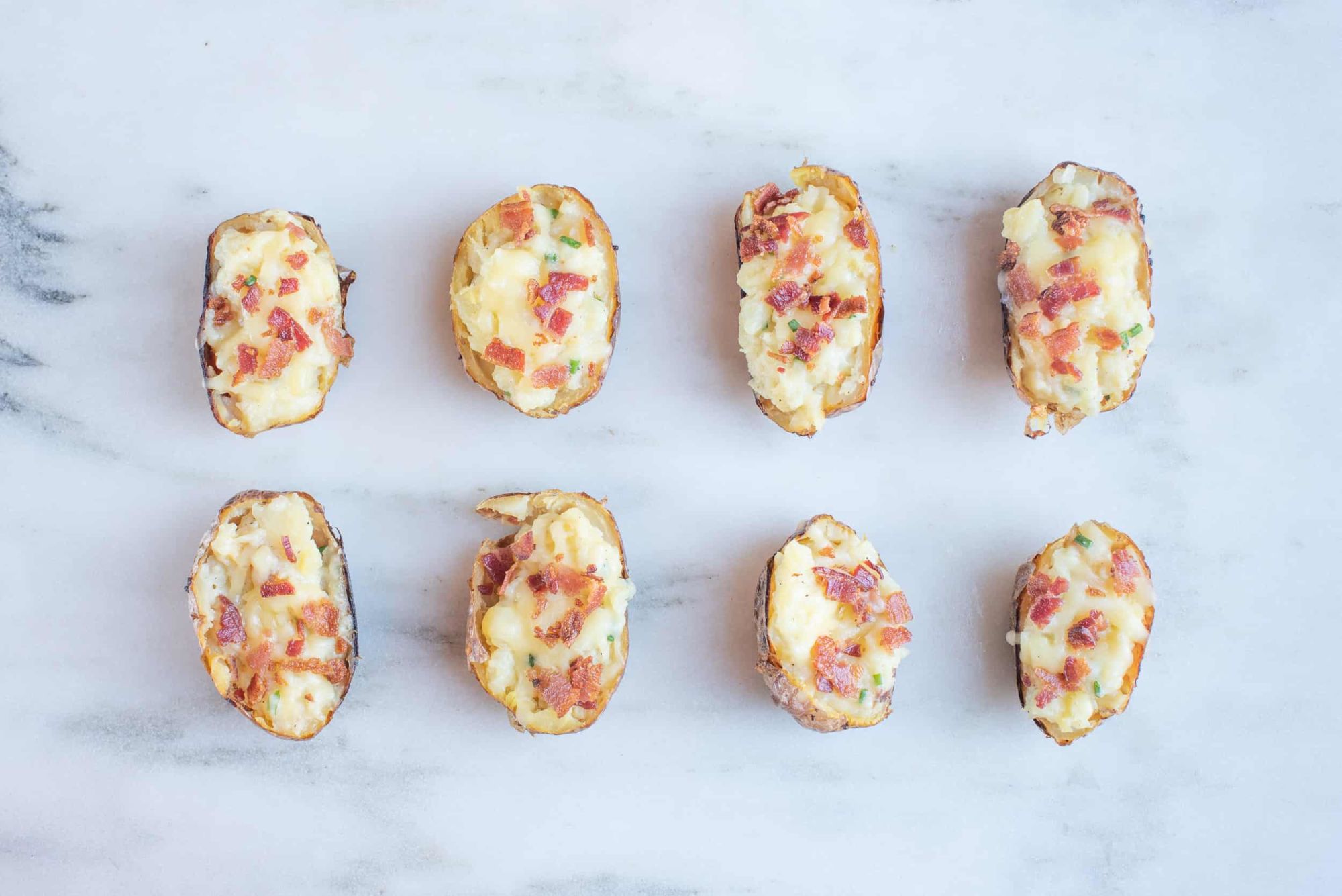 eight potato halves cooked with cheese and bacon for toddlers