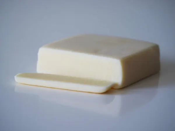 a block of Monterey Jack cheese with a slice cut off in the front for babies starting solids