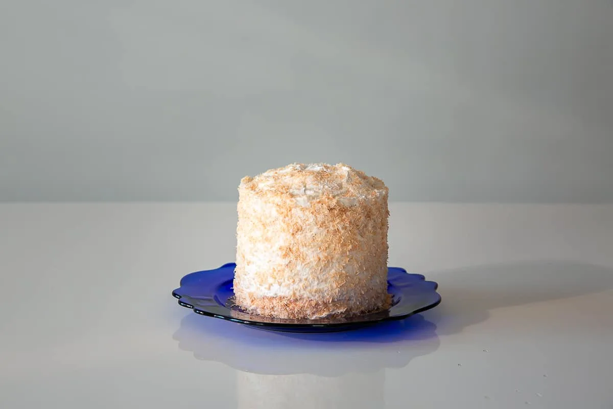 a yellow smash cake on a blue plate