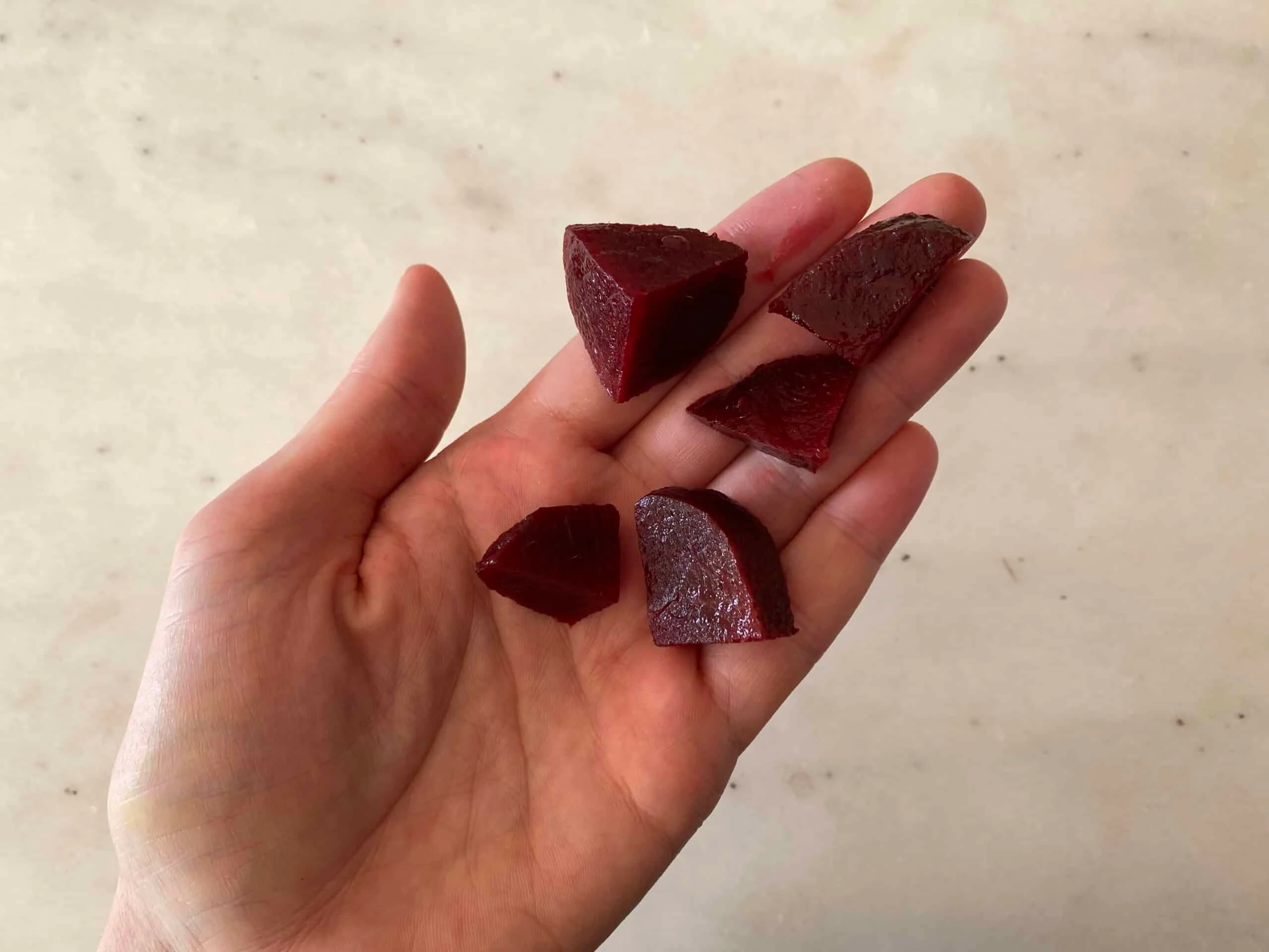 Beet cooked bite-sized pieces hand pic