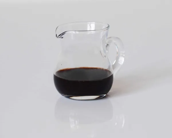 a small glass pitcher a third full of balsamic vinegar