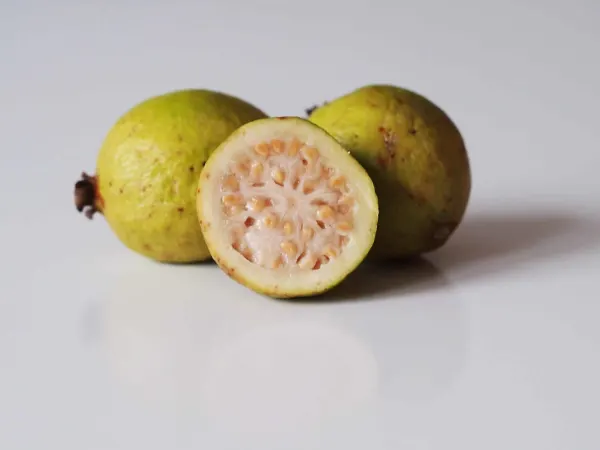 A yellow guava cut open before being prepared for babies starting solid food
