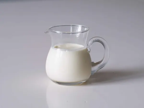 a glass pitcher of milk before being served to babies starting solids