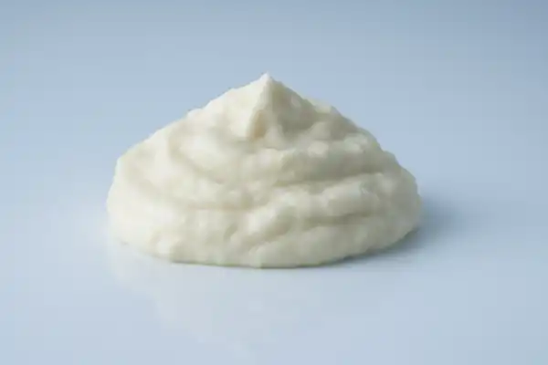 a photograph of a pile of soy yogurt on a white background