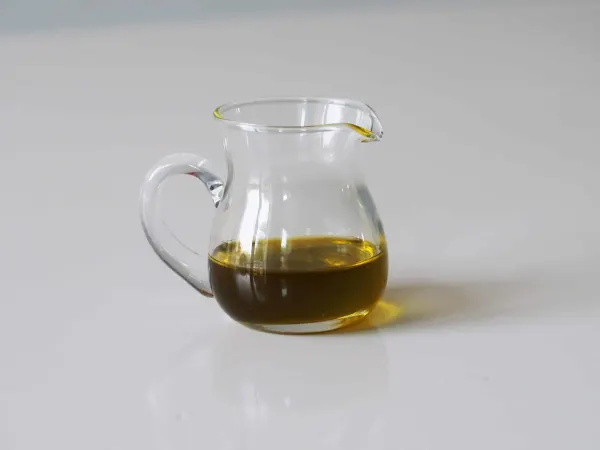 A glass pitcher of olive oil before being served to babies starting solid food