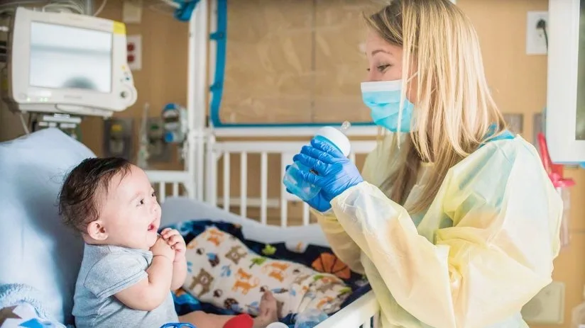 Kim Grenawitzke pediatric OT working with a baby