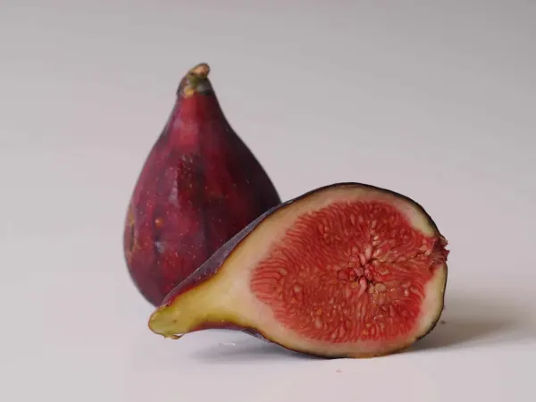 A fig sliced in half before being prepared for babies starting solid food